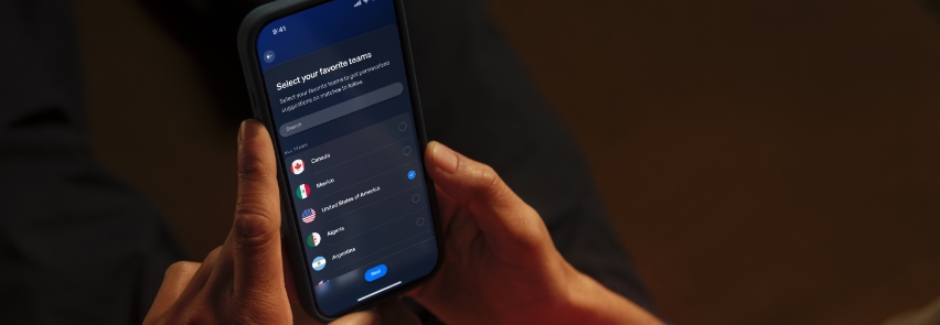 Gruppe venner jubler og feirer fotballmål i stuen med dynamisk Philips Hue Sports Live-belysning i røde farger